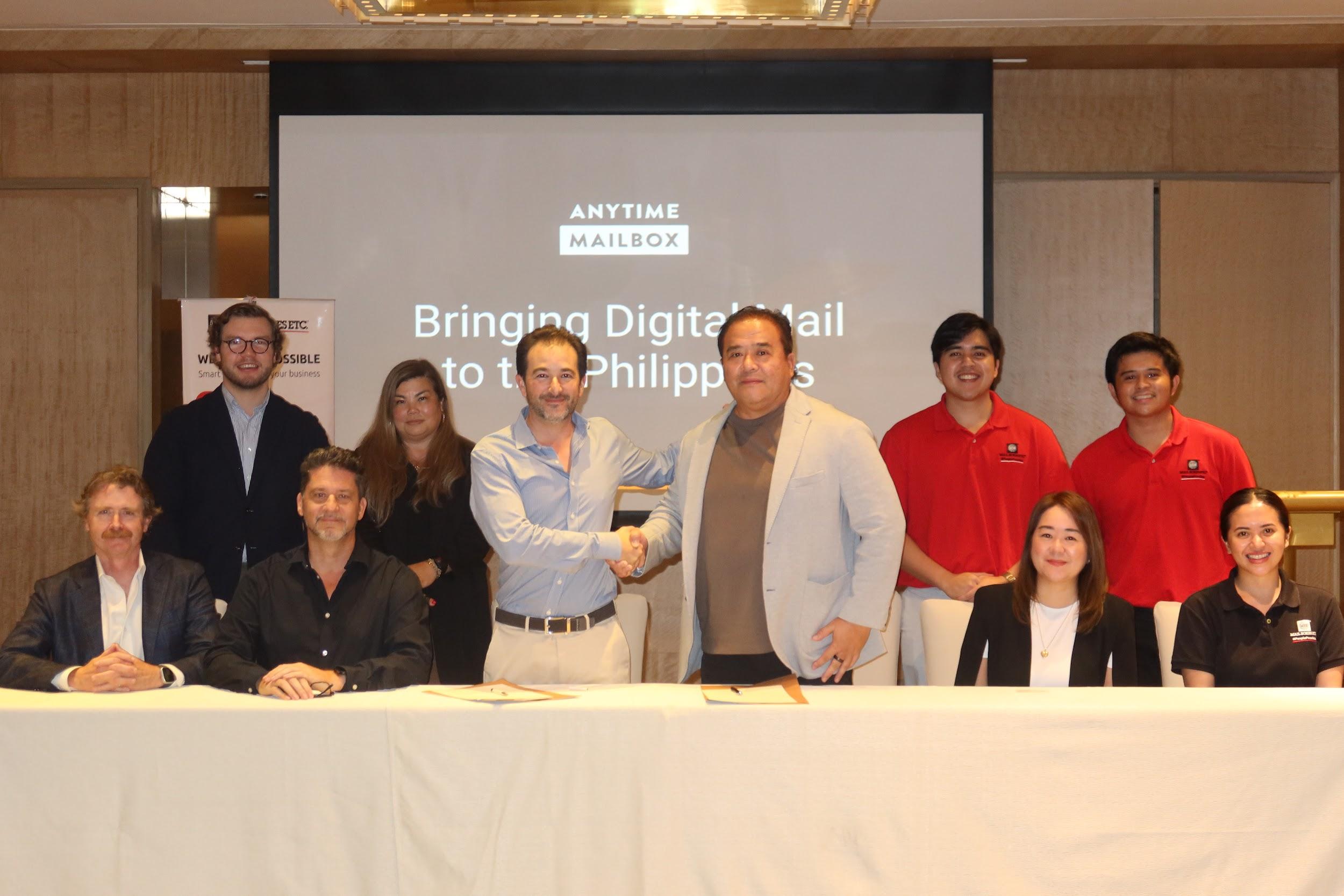 Mail Boxes Etc. Philippines Chairman Norman Fulgencio (center right) and Anytime Mailbox Executive Chairman and Co-Founder Matt Going (center left) finalize their partnership with a signed contract and a firm handshake.