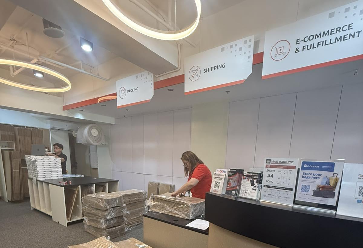 MBE PH staff member packs a box securely for international shipment.